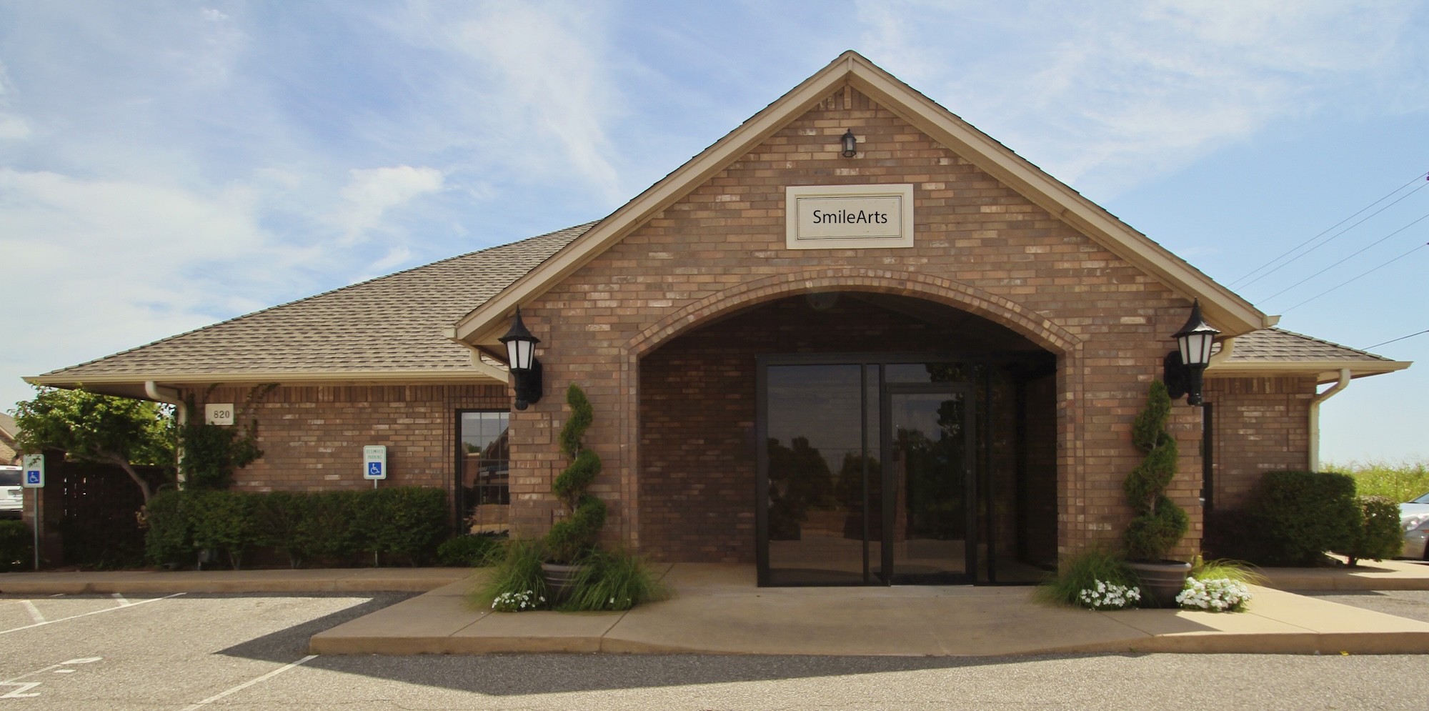 The image shows a building with a sign that reads  Woodland Park,  indicating it s likely an establishment within Woodland Park, possibly a hotel or restaurant.